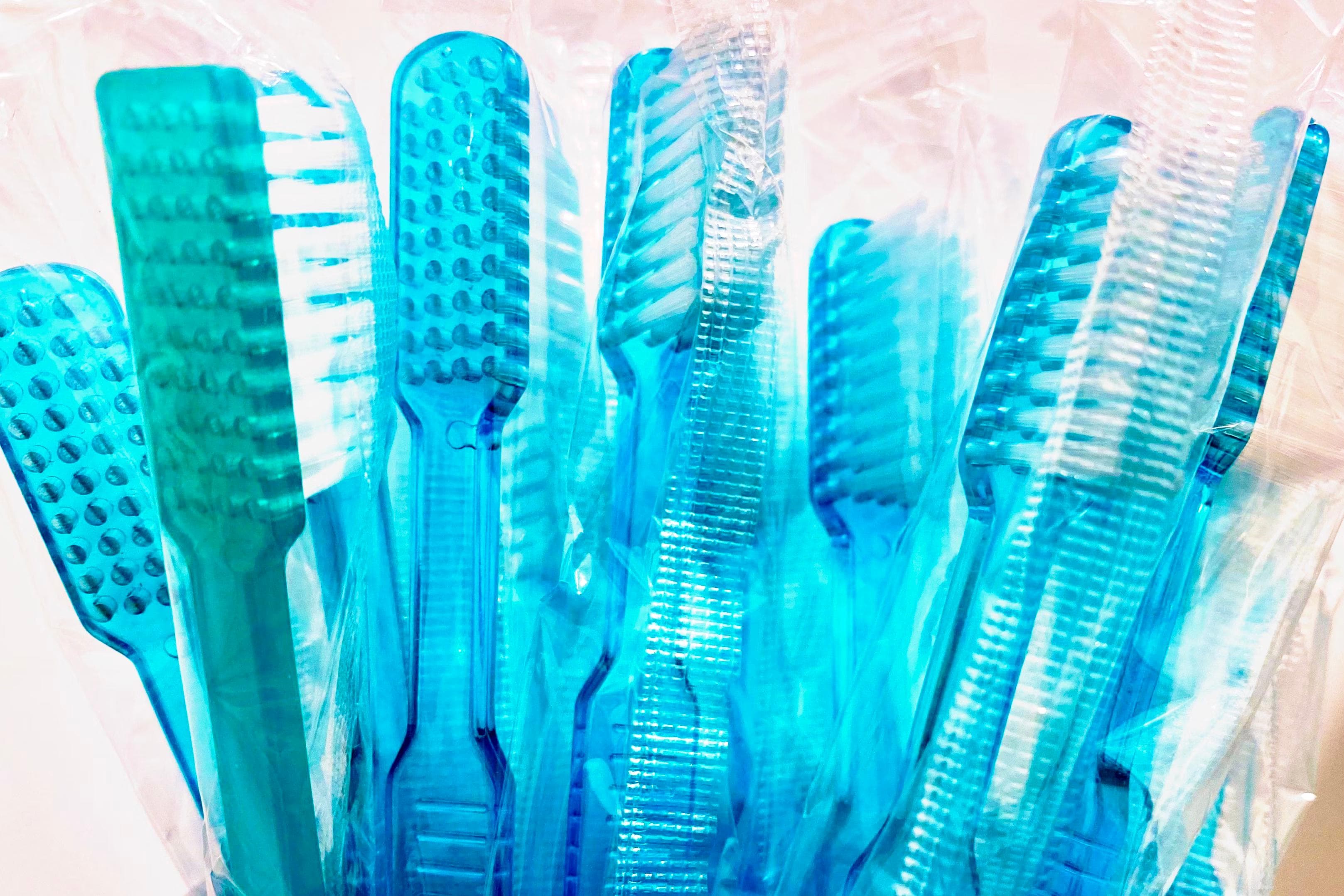 plastic single use toothbrushes in bag